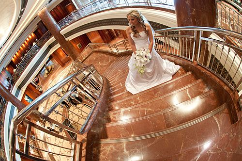 Wedding Photography Melbourne featuring a bride and the staircase at the Park Hyatt Hotel. Wedding Photographers Melbourne image of a bride standing on the grand staircase in the foyer of the Park Hyatt Hotel.
