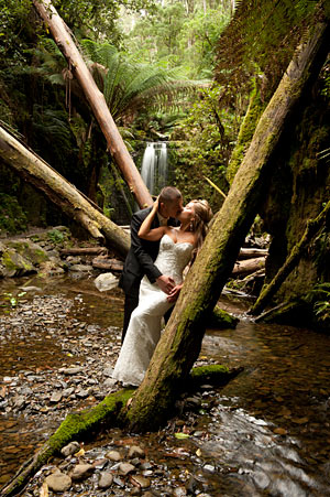 Wedding Photographers Melbourne feature a waterfall in this bridal portrait. A bridal portrait of a wedding couple in a waterfall setting outside Melbourne.
